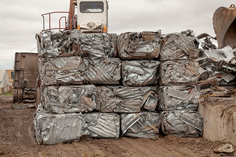 Bales of crushed metal sit in the farm yard of a Minnesota farm destroyed by a 2018 tornado